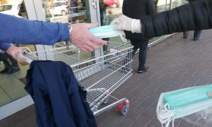 Mascherine distribuite a chi fa la spesa davanti alla Coop